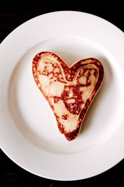 Heart shaped toast on white ceramic plate