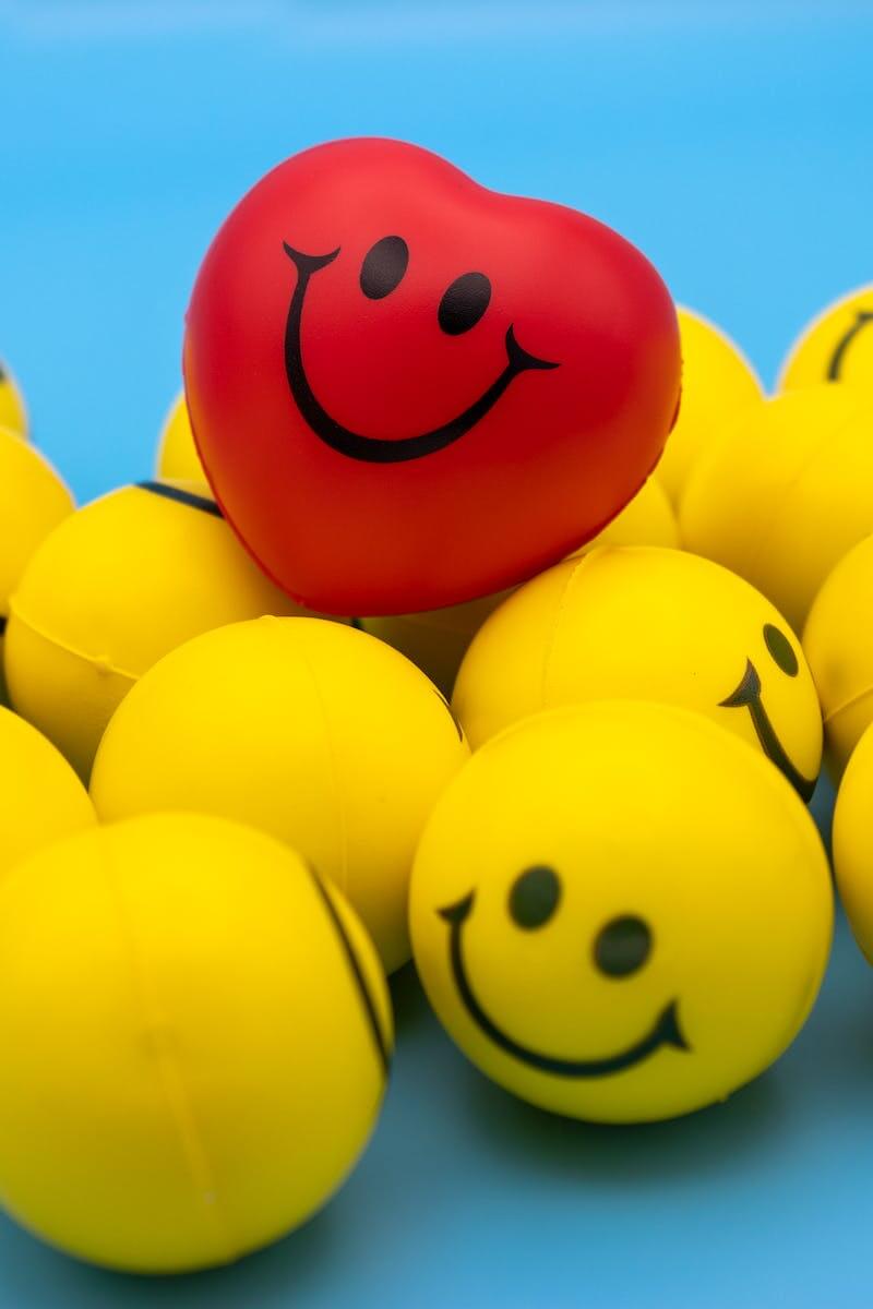 smiley yellow balls and heart-shaped red ball